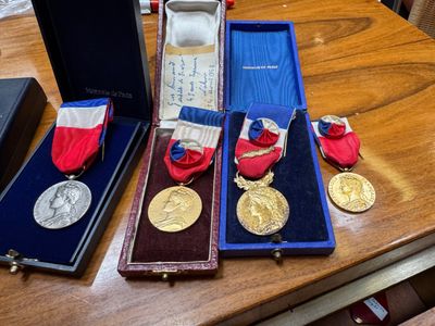 three medals sitting in a case on a table