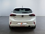 the rear end of a white car in a white room