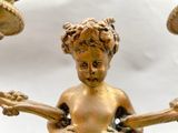 a statue of a little boy holding a guitar in his hands