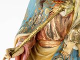 a statue of jesus holding a staff in his hands