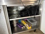 a stainless steel cabinet with dishes and pans on it