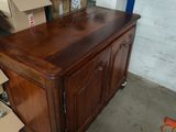 a wooden cabinet with a clock on top of it