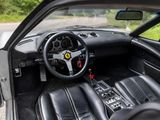 the interior of a black sports car with a steering wheel and dashboard