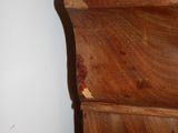 a close up of a wooden cabinet with a marble top