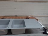two sinks sitting on a table in a garage