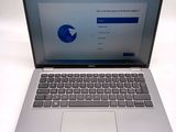 a laptop computer sitting on a table with a keyboard