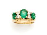 an emerald and diamond three stone ring