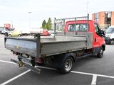 a red truck that is parked in a parking lot