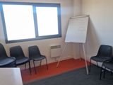 a room with chairs and a white board in it