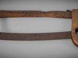 an old hand saw with a wooden handle on a white surface