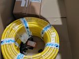a yellow hose sitting inside of a box with a box in the background