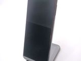 a cell phone that is sitting on top of a stand