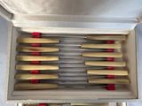 a bunch of knives in a box on a table