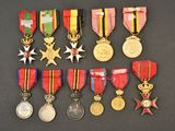 several medals and medals are displayed on a black surface