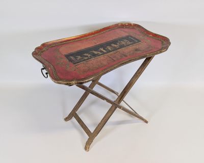 an old tray with a sign on it sitting on a stand