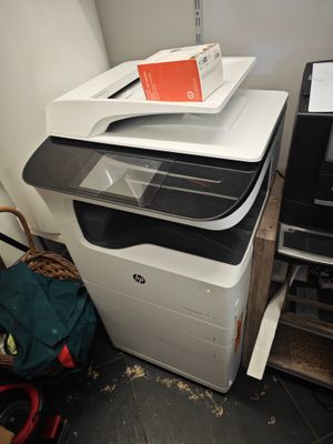 a printer sitting on top of a printer next to a printer