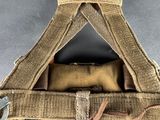 the back of a tan bag with two straps attached to it