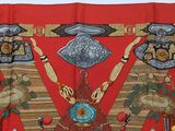 an image of a red cloth with native art on it