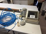 a table with a bunch of wires and a computer on it