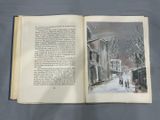 an open book with a picture of a street scene in it