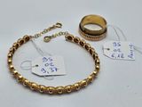 two gold bracelets and a ring with a price tag on them