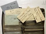 a suitcase full of old letters and papers on the table
