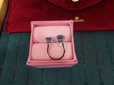 a pink box with two rings in it and a red bag