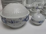 a lot of dishes and cups on the table