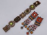 two pairs of bracelets on a white surface with a white background