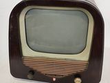 an old fashioned television sitting on a white surface