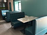 a blue booth with a table and two chairs in it