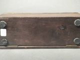 an old wooden box with screws on it