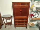 a small table and a cabinet in the corner of a room
