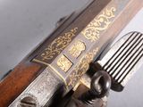 a close up of a gun with a knife in it