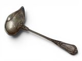 an antique spoon with a metal handle on a white surface
