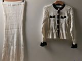 two pieces of clothing hanging on a wall next to a hanger