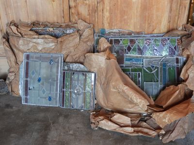 many pieces of stained glass sitting on the floor