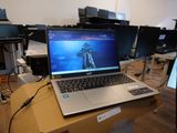 a laptop computer sitting on top of a desk in a room