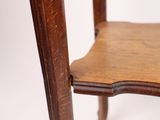 the back of a chair with a wooden seat on a white background