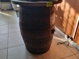 a laptop on top of a barrel on the floor