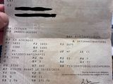 the receipt is being held up by a person holding a cell phone