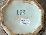 a close up of a vase with a tag on it
