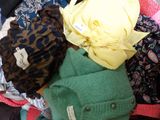a pile of clothes that is sitting on the floor