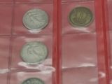 a lot of coins in a red case on the table