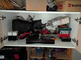 a cabinet with tools and other items in it