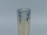 a white vase with blue designs on it on a table