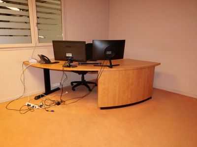 un bureau sur lequel se trouvent deux écrans d'ordinateur et un téléphone