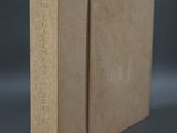 a close up of a brown book with a black background