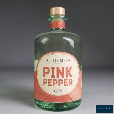 a bottle of pink pepper gin sitting on a table