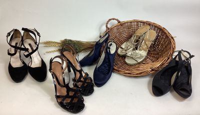 several pairs of women ' s shoes and a basket on a table